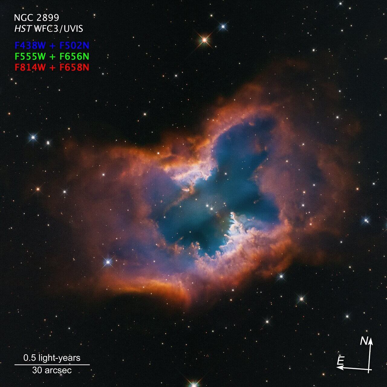 This Hubble Space Telescope image captures the beauty of the moth-like planetary nebula NGC 2899. This object has a diagonal, bipolar, cylindrical outflow of gas. This is propelled by radiation and stellar winds from a nearly 22 000 degree Celsius white dwarf at the center. In fact, there may be two companion stars that are interacting and sculpting the nebula, which is pinched in the middle by a fragmented ring or torus – looking like a half-eaten donut. It has a forest of gaseous “pillars” that point back to the source of radiation and stellar winds. The colours are from glowing hydrogen and oxygen. The nebula lies approximately 4,500 light-years away in the southern constellation Vela. Credit: NASA, ESA, STScI