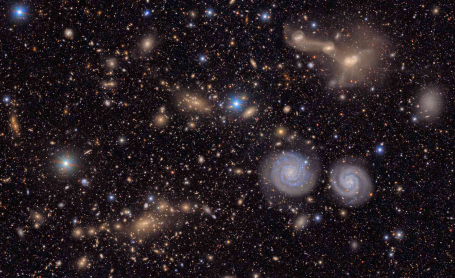 Questa immagine mostra una piccola sezione della vista complessiva dell’ammasso della Vergine ottenuta dal Vera C. Rubin Observatory. Sono visibili due prominenti galassie a spirale (in basso a destra), tre galassie in fase di fusione (in alto a destra), diversi gruppi di galassie lontane, molte stelle appartenenti alla Via Lattea e altro ancora. Crediti: NSF-DOE Vera C. Rubin Observatory