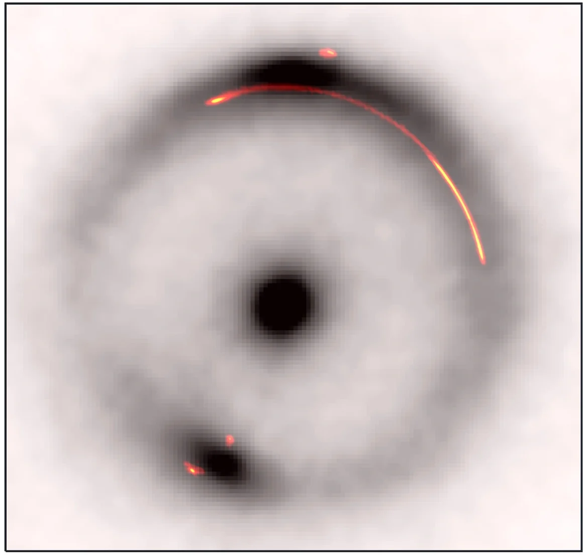 Sovrapposizione dell'emissione infrarossa (in bianco e nero) con l'emissione radio (a colori) dell’arco gravitazionale del sistema JVAS B1938+666. L'oggetto oscuro e di piccola massa si trova nel vuoto nella parte luminosa dell'arco sul lato destro. Crediti: Keck/EVN/GBT/VLBA/John McKean